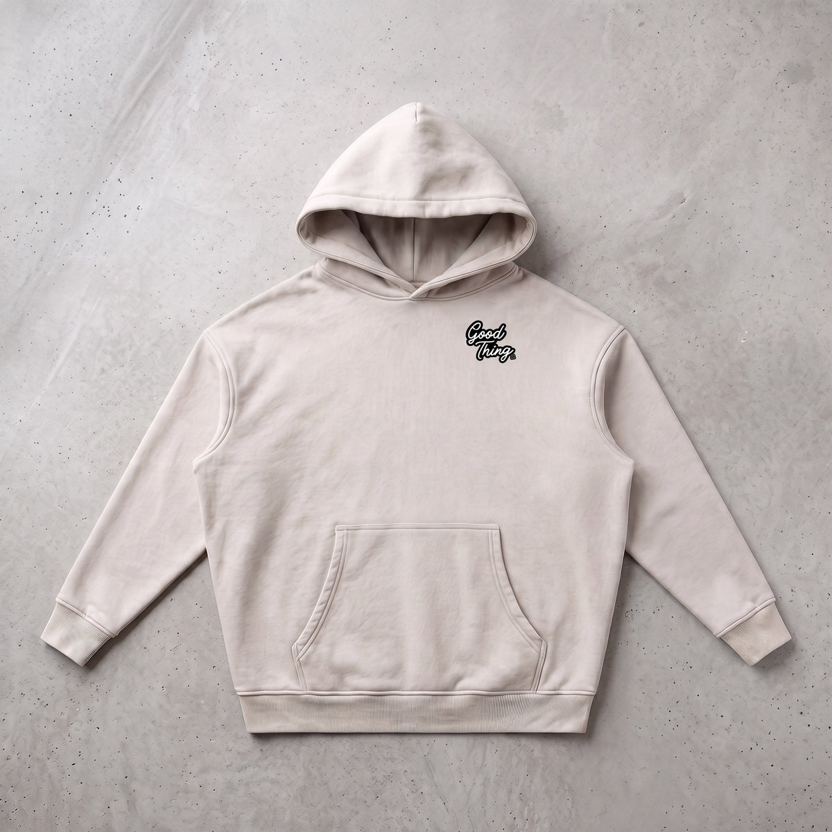 Good Thing & Co. oversized beige snow wash fleece hoodie with drop shoulders and front logo.