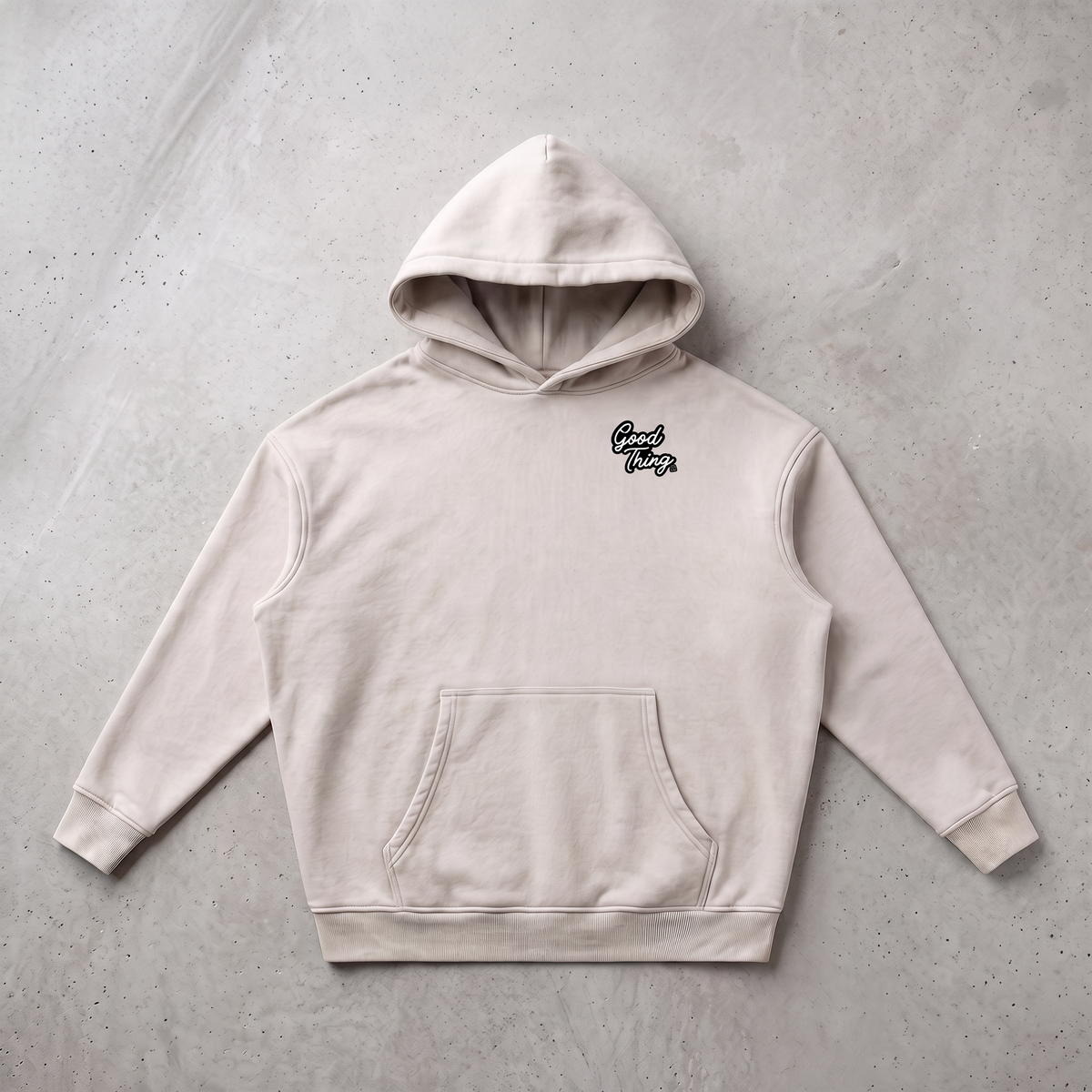 Good Thing & Co. beige oversized fleece hoodie with a snow wash finish, drop shoulders, and a front kangaroo pocket.