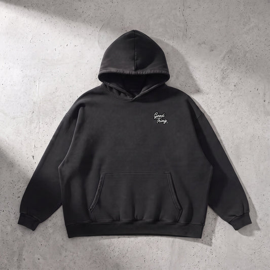 Good Thing & Co. black heavyweight cotton hoodie with a vintage wash, drop shoulders, and a front patch pocket.