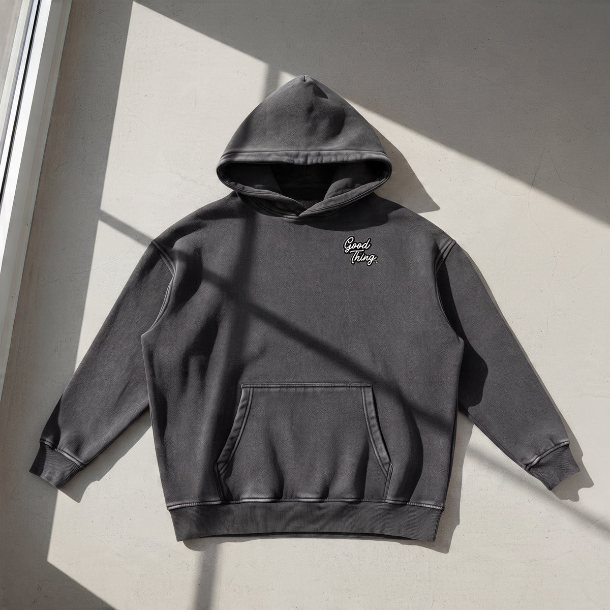 Good Thing & Co. charcoal grey oversized hoodie with a snow wash finish, drop shoulders, and front kangaroo pocket.