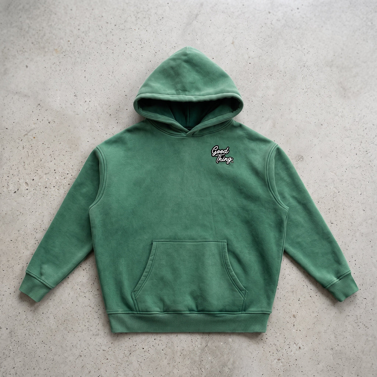 Good Thing & Co. green oversized fleece hoodie with a snow wash finish, drop shoulders, and a front kangaroo pocket.