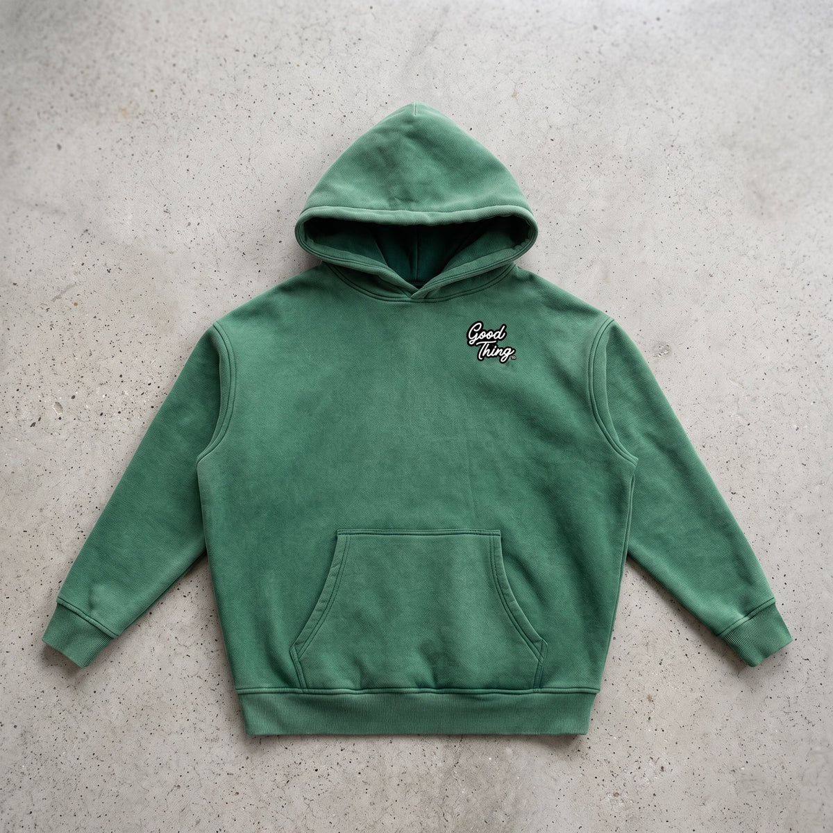Good Thing & Co. green oversized fleece hoodie with a snow wash finish, drop shoulders, and front kangaroo pocket.